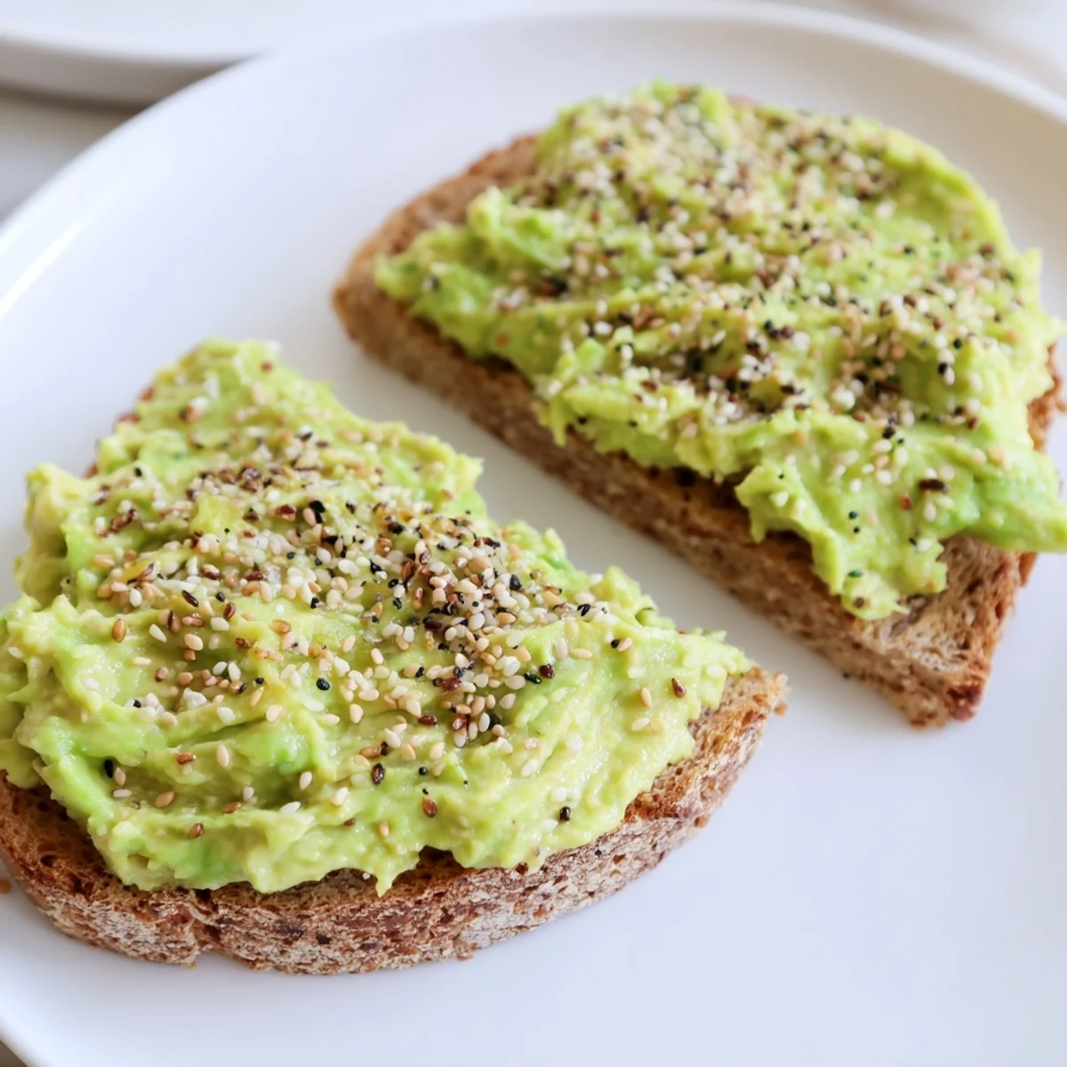 Creamy avocado covers toasted bread, sprinkled with everything seasoning for this mouthwatering Avocado Toast.