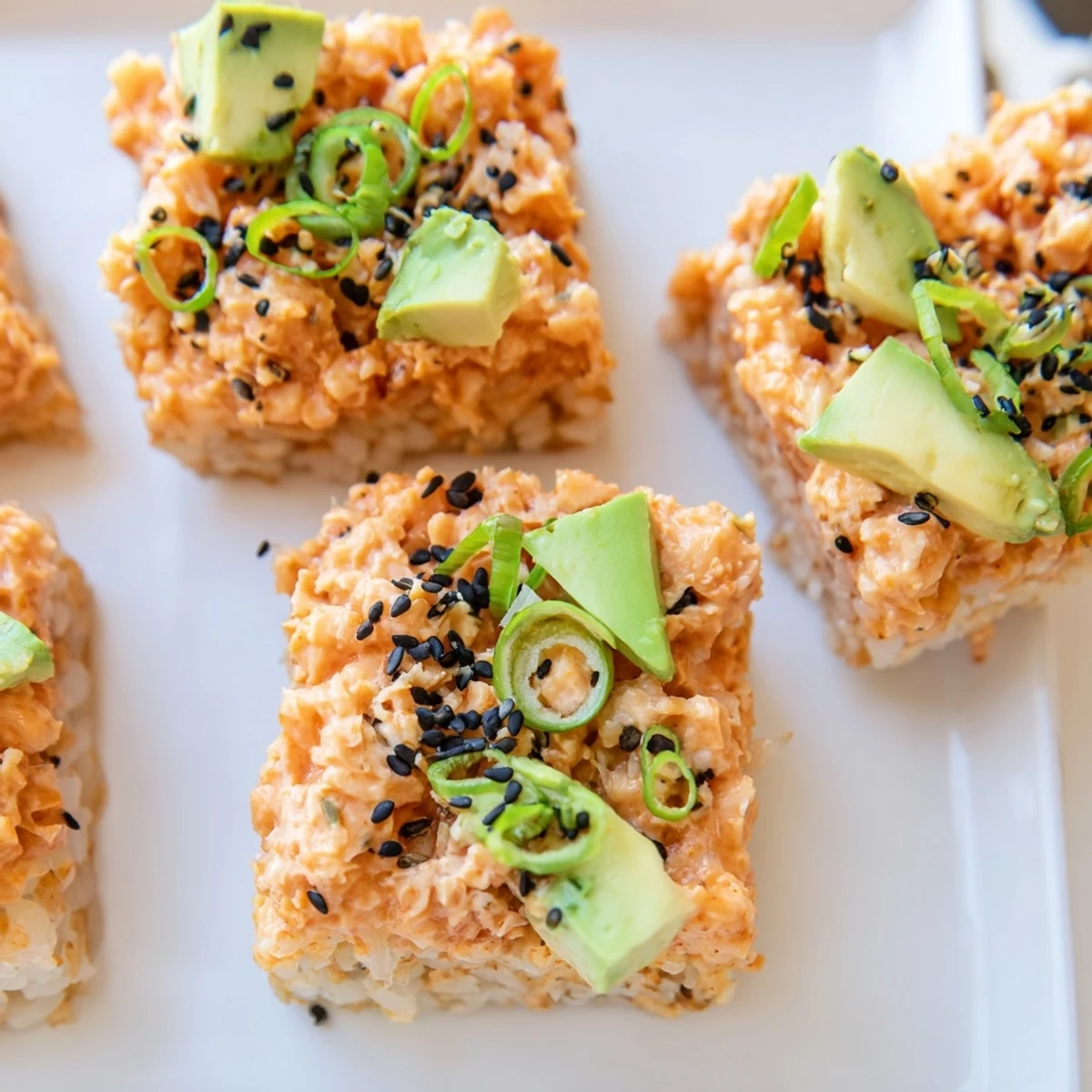 Golden-brown Spicy Tuna Crispy Rice appetizers are topped with creamy, ruby-red tuna mixture.
