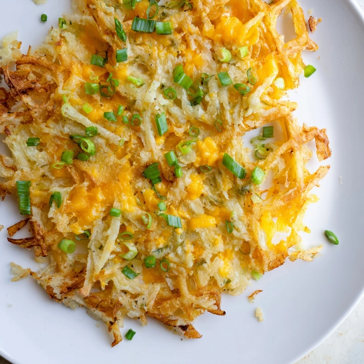 Golden-brown Cheesy Hash Brown Waffles, crispy from the waffle iron, ready to enjoy with savory toppings.