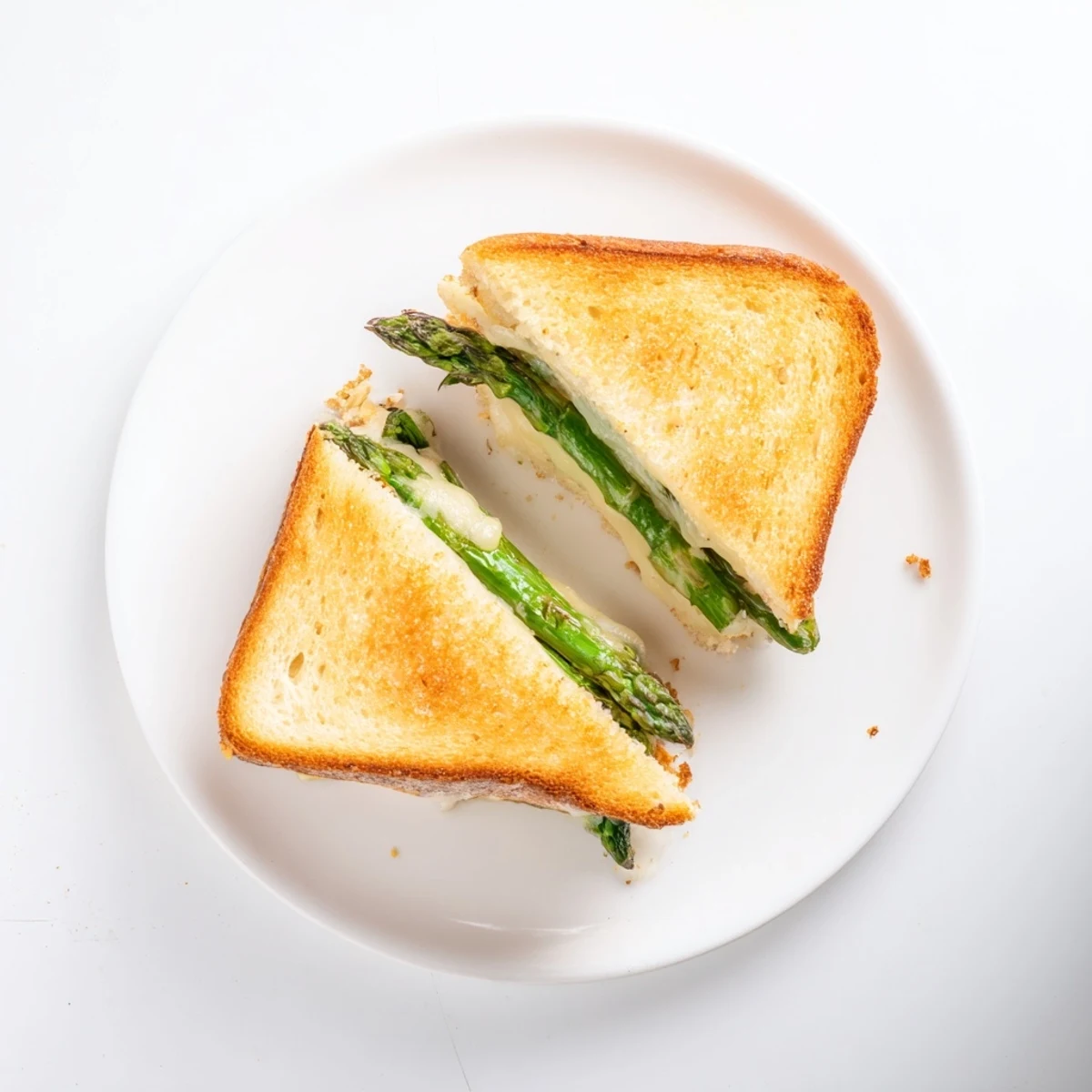 Golden-brown sourdough slices frame the warm, melted Brie and charred asparagus in this Asparagus & Brie Grilled Cheese, perfect for a spring lunch.