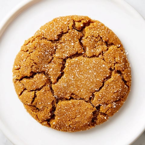 A warm plate of soft-baked ginger and molasses cookies, ready to be enjoyed.