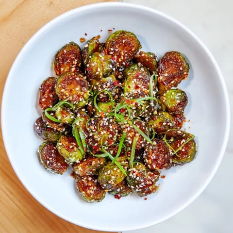 Savory Honey-Soy Glazed Brussels Sprouts, glistening with glaze, perfect for a flavorful weeknight meal.