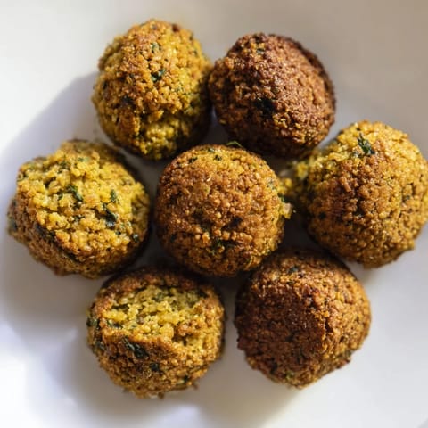 Deep-fried Levantine falafel balls, boasting a perfect, crunchy exterior and soft interior, ideal for sharing.