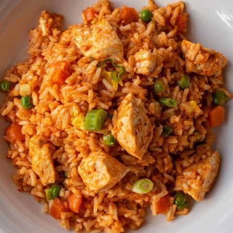 Steaming plate of Butter Chicken Fried Rice garnished with green onions, a quick fusion meal for busy weeknights.