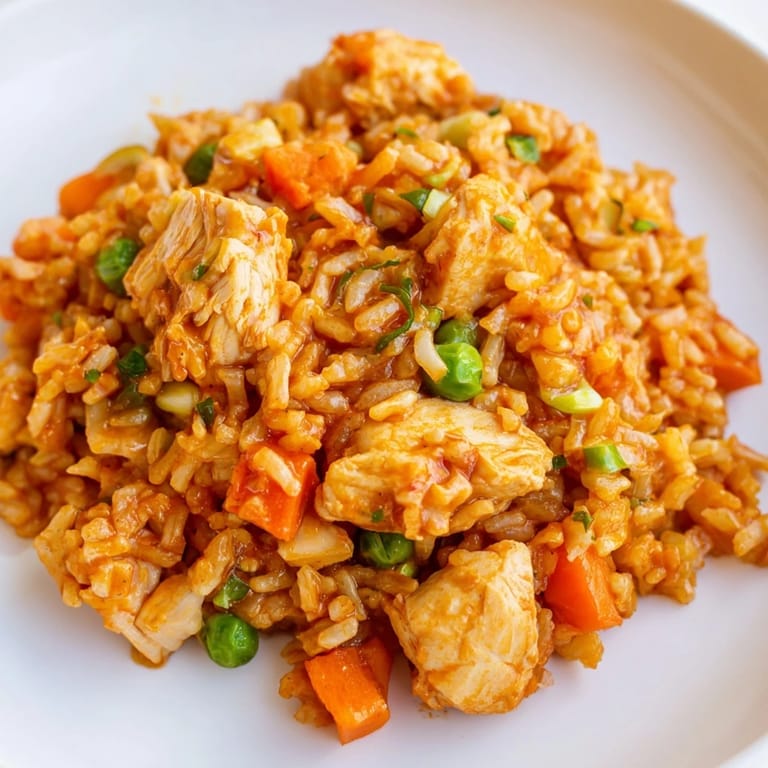 Spicy Butter Chicken Fried Rice combines tender chicken, fluffy rice, and colorful veggies in a savory, buttery coating.