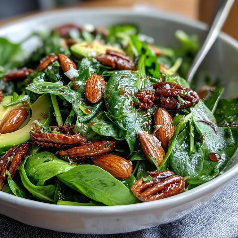 Fresh and colorful spring green salad with honey mustard and almonds, served as a refreshing light lunch or appetizer.